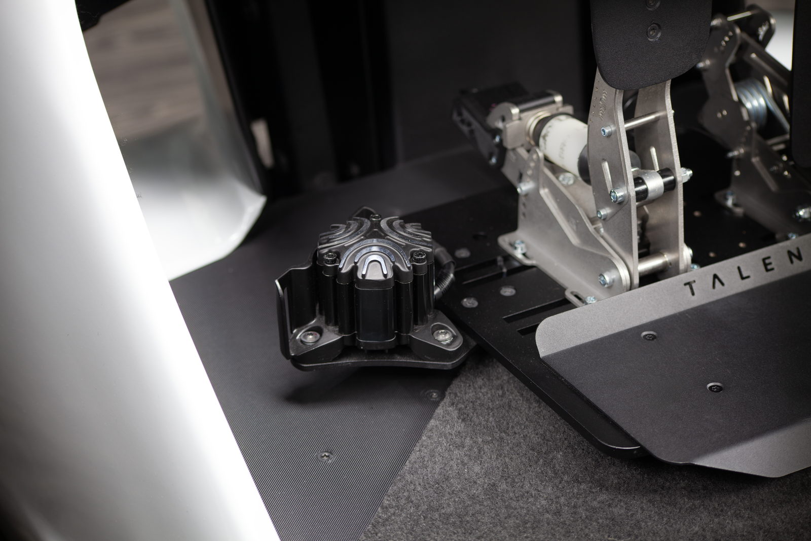 Tactile transducer mounted beside the pedal deck